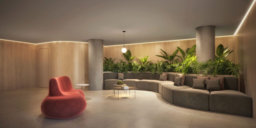 Perspectiva do sofisticado lobby, com um sofá em formato orgânico e poltrona com design diferenciado.